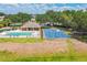 A view of a community basketball court and pool area, surrounded by manicured green spaces at 807 Ayden Oak Ln, Ocoee, FL 34761