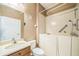 Bathroom with accessible tub, wooden vanity, and tile surround at 807 Ayden Oak Ln, Ocoee, FL 34761