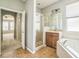 Bathroom featuring tile floors, shower with glass door, bathtub, sink, and light fixtures at 807 Ayden Oak Ln, Ocoee, FL 34761