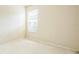 Bright bedroom with neutral carpet, light-colored walls, and a single window at 807 Ayden Oak Ln, Ocoee, FL 34761