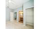 Bedroom with light blue walls, carpet, open closet, and bathroom view at 807 Ayden Oak Ln, Ocoee, FL 34761