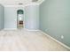 Spacious bedroom featuring neutral carpet, light blue walls, and an arched entryway to another room at 807 Ayden Oak Ln, Ocoee, FL 34761