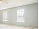 Spacious bedroom includes two windows for natural light, and light grey painted walls at 807 Ayden Oak Ln, Ocoee, FL 34761