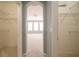 View from closet into bedroom with carpet, a fan, three rear windows, and walls painted light blue at 807 Ayden Oak Ln, Ocoee, FL 34761