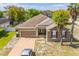 Charming single-story home with a brick driveway, a two-car garage, and two palm trees at 807 Ayden Oak Ln, Ocoee, FL 34761