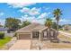 Charming single-story home showcasing a brick driveway, well-maintained yard and picturesque palm trees at 807 Ayden Oak Ln, Ocoee, FL 34761