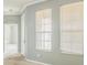 Foyer boasts natural light from two large windows and decorative glass front door at 807 Ayden Oak Ln, Ocoee, FL 34761