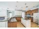 Spacious kitchen features stainless steel appliances, granite countertops, a kitchen island and tile backsplash at 807 Ayden Oak Ln, Ocoee, FL 34761