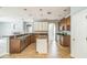 Well-lit kitchen showcases stainless steel appliances, granite counters, a kitchen island, and tiled floors at 807 Ayden Oak Ln, Ocoee, FL 34761
