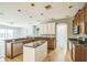 Bright kitchen features modern appliances, granite countertops, kitchen island and bar, and tile backsplash at 807 Ayden Oak Ln, Ocoee, FL 34761