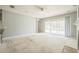 Bright living room featuring a ceiling fan, natural light, and sliding doors to the backyard pool at 807 Ayden Oak Ln, Ocoee, FL 34761