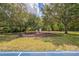Community playground featuring swings, slides, and benches under mature trees at 807 Ayden Oak Ln, Ocoee, FL 34761