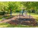Community playground featuring multiple swings, slides and picnic table under the shade of mature trees at 807 Ayden Oak Ln, Ocoee, FL 34761