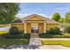 View of the gated entrance to the community pool area featuring beautiful green landscaping around the building at 807 Ayden Oak Ln, Ocoee, FL 34761