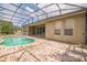 Screen-enclosed pool with brick-paved patio, offering privacy and outdoor enjoyment at 807 Ayden Oak Ln, Ocoee, FL 34761