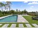Inviting backyard featuring a pool, lush green lawn, and outdoor lounging area at 8105 Fenton St, Orlando, FL 32836