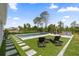 Beautiful backyard showcasing a sparkling pool, lush landscaping, and outdoor seating at 8105 Fenton St, Orlando, FL 32836