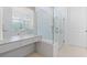 Modern bathroom featuring a glass-enclosed shower, vanity, and neutral tile at 8105 Fenton St, Orlando, FL 32836