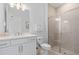 Elegant bathroom with a walk-in shower, white vanity, and modern fixtures at 8105 Fenton St, Orlando, FL 32836