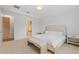 Bright bedroom with white walls, carpet flooring, and a king-size bed with a bench at 8105 Fenton St, Orlando, FL 32836