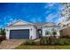 Charming one-story home featuring a two-car garage and lush landscaping at 8105 Fenton St, Orlando, FL 32836