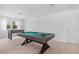Bright game room featuring a pool table and foosball table, perfect for entertaining guests at 8105 Fenton St, Orlando, FL 32836