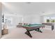 Spacious game room with a pool table, foosball table, and plenty of natural light at 8105 Fenton St, Orlando, FL 32836