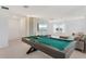 Elegant game room with a pool table, modern entertainment center, and cozy seating area at 8105 Fenton St, Orlando, FL 32836