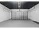Spacious garage featuring an epoxy floor and a modern garage door, offering ample space for parking and storage at 8105 Fenton St, Orlando, FL 32836