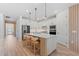 Modern kitchen island features seating, stainless steel appliances, and white cabinets at 8105 Fenton St, Orlando, FL 32836