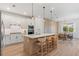 Modern kitchen features an island with bar seating, stainless appliances, and an adjacent dining area at 8105 Fenton St, Orlando, FL 32836
