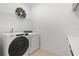 Bright laundry room with modern Whirlpool washer and dryer, complemented by ample storage and a stylish decorative accent at 8105 Fenton St, Orlando, FL 32836