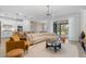 Open-concept living room flowing into kitchen and dining area, featuring a modern design at 8105 Fenton St, Orlando, FL 32836