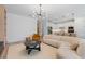 Open-concept living room flows into a modern kitchen with pendant lighting and stainless steel appliances at 8105 Fenton St, Orlando, FL 32836