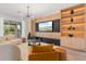 Contemporary living room with modern lighting and a large screen TV with built-in shelves at 8105 Fenton St, Orlando, FL 32836