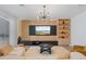 Bright living room with a modern light fixture, neutral sofa, and stylish decor at 8105 Fenton St, Orlando, FL 32836