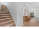 Open concept living space with stairs, kitchen, dining area, and plank wood flooring at 8105 Fenton St, Orlando, FL 32836