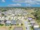 Aerial view of a charming home nestled within a vibrant suburban neighborhood with scenic green views at 822 Sheen Cir, Haines City, FL 33844