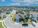 Aerial view of a home in a suburban neighborhood with well-maintained lawns and mature trees at 822 Sheen Cir, Haines City, FL 33844