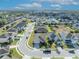 Aerial view of a home in a suburban neighborhood with well-maintained lawns and mature trees at 822 Sheen Cir, Haines City, FL 33844