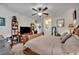Spacious bedroom with a ceiling fan, bedside table, and dark brown wooden furniture at 822 Sheen Cir, Haines City, FL 33844