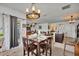 Cozy dining area with wood table, stylish chandelier, and open layout into the kitchen and living room at 822 Sheen Cir, Haines City, FL 33844