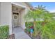 Inviting front entryway featuring decorative plants and a wreath adorning the front door at 822 Sheen Cir, Haines City, FL 33844