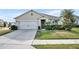 Charming single-story home with a well-manicured lawn, a two-car garage, and a welcoming front entrance at 822 Sheen Cir, Haines City, FL 33844