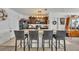 Well-equipped kitchen with granite counters, dark wood cabinets, stainless steel appliances, and bar seating at 822 Sheen Cir, Haines City, FL 33844