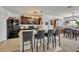 Open kitchen featuring granite countertops, dark cabinetry, and bar seating for four at 822 Sheen Cir, Haines City, FL 33844