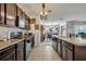 Spacious kitchen with tile flooring, dark wood cabinets, and stainless steel appliances at 822 Sheen Cir, Haines City, FL 33844
