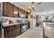 Kitchen featuring dark cabinets, stainless appliances, and open access to the dining area at 822 Sheen Cir, Haines City, FL 33844