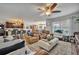 Open-concept living space with comfortable seating, a view of the kitchen, and a ceiling fan at 822 Sheen Cir, Haines City, FL 33844