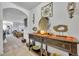 Inviting entryway with stylish console table, decorative art, and an archway into the living room at 822 Sheen Cir, Haines City, FL 33844